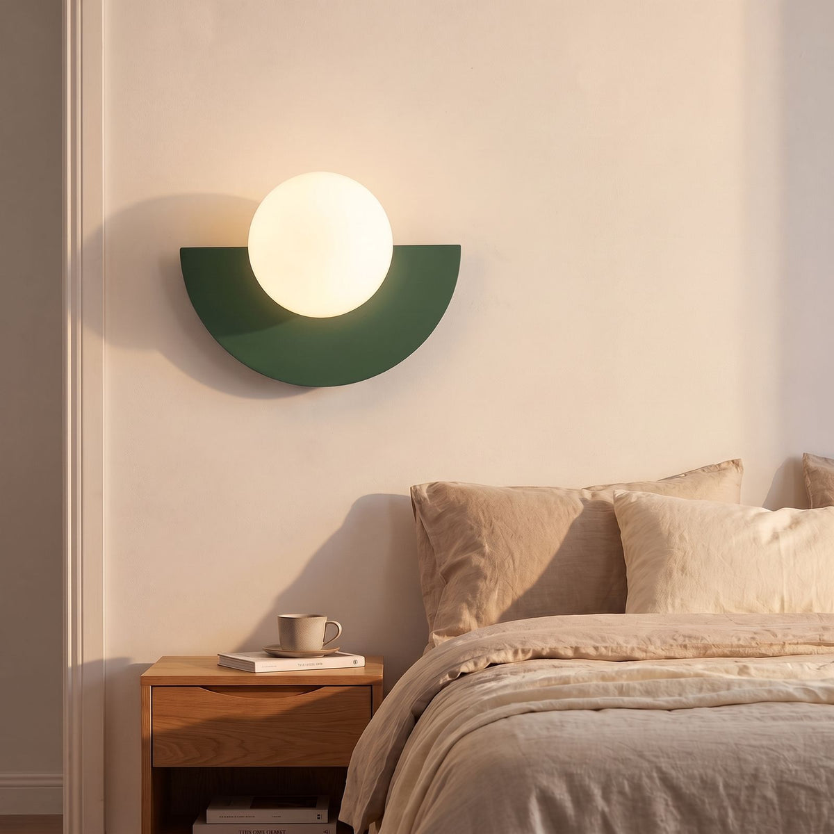 Half Moon Iron and Opal Globe Wall Light in green beside a bed