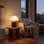 Half Moon Shade Bamboo Base Table Lamp beside a reading armchair
