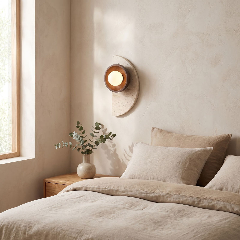 Half Moon Travertine and Wood Wall Light on a bedroom wall beside the bed