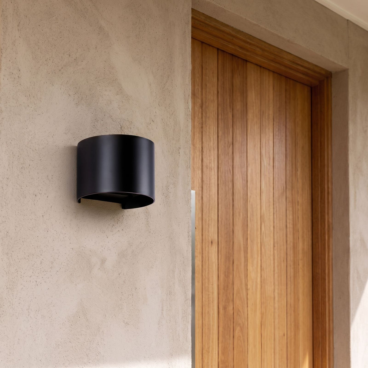 Half Round Up Down Outdoor Wall Light beside a timber front door