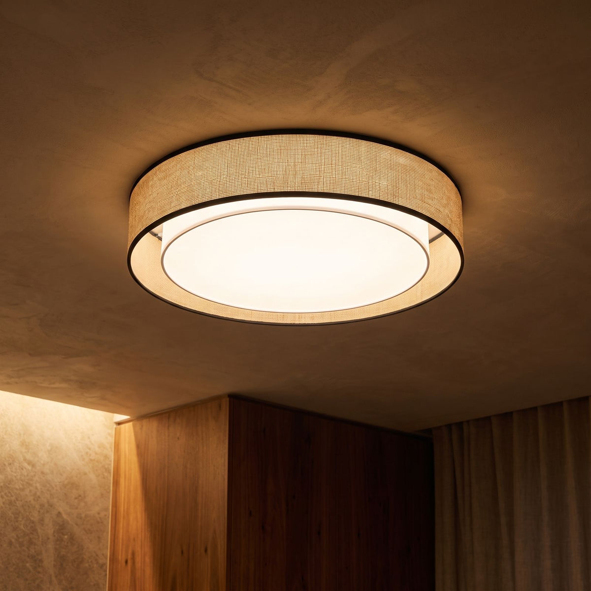 Hand-Woven Acrylic Drum Shade Ceiling Light glowing on a ceiling at night