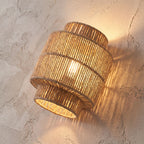 Hand Woven Natural Fibre Up Down Wall Light, close view at 45 degrees on a plaster wall