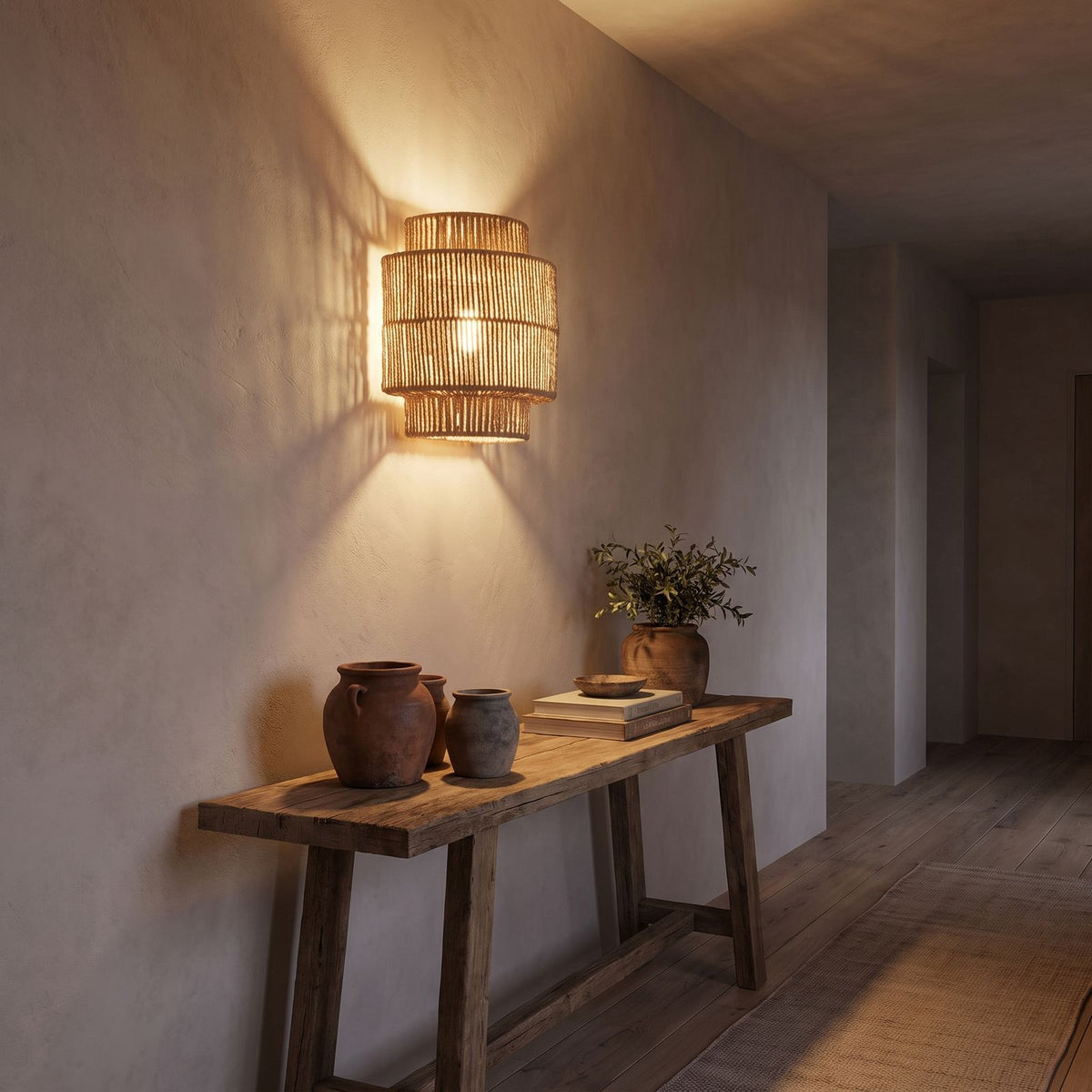 Hand Woven Natural Fibre Up Down Wall Light in a hallway above a timber console