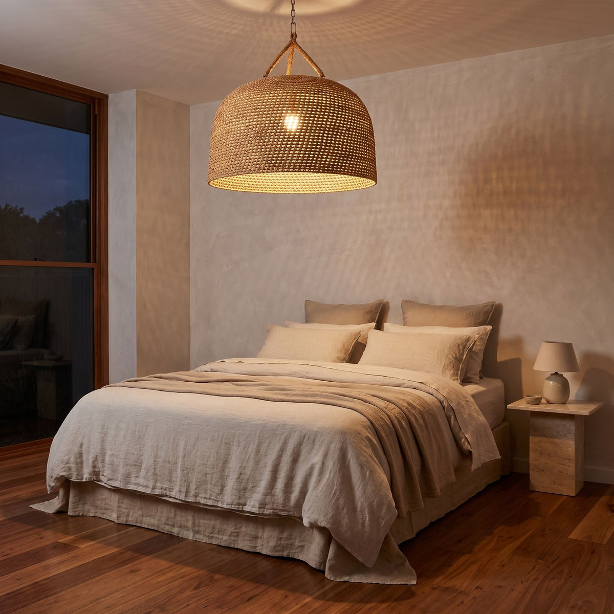 Handwoven Rattan Japandi Pendant Light centred above a bed