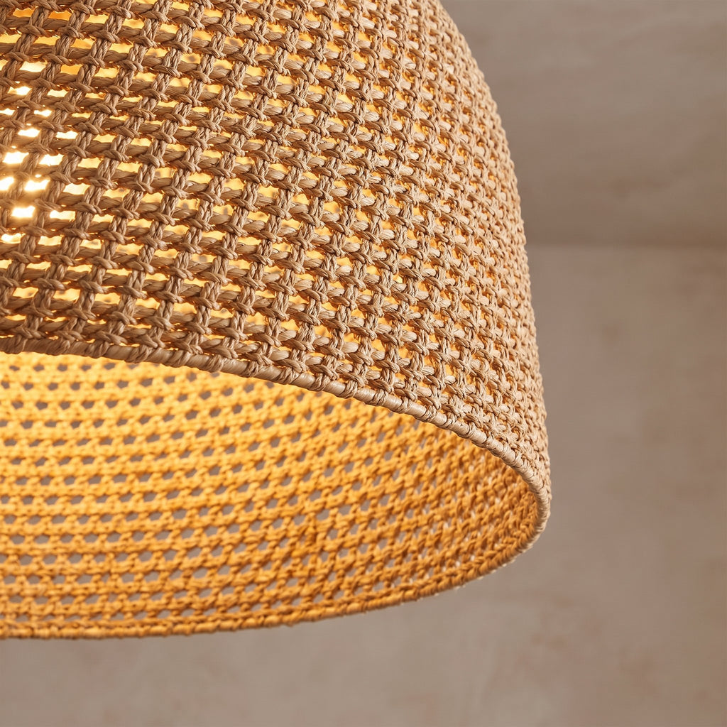 Close view of the handwoven rattan rope weave with the light glowing through