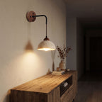 Hanging Travertine Shade LED Wall Light in a hallway above a timber console
