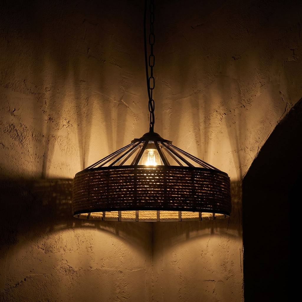 Hemp Rope and Iron Cage Pendant Light glowing against a plaster wall at night