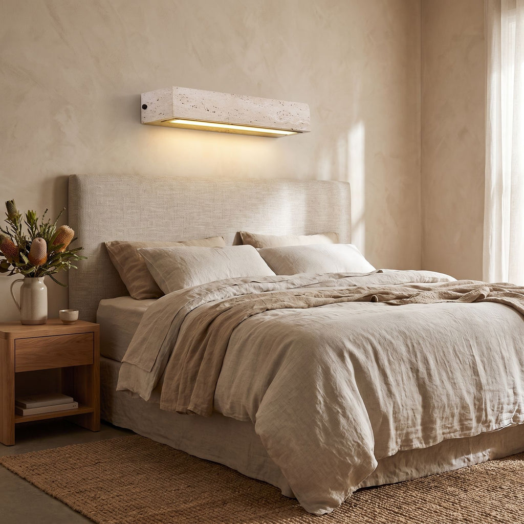 Horizontal Yellow Travertine Bar Wall Light on a bedroom wall beside the bed
