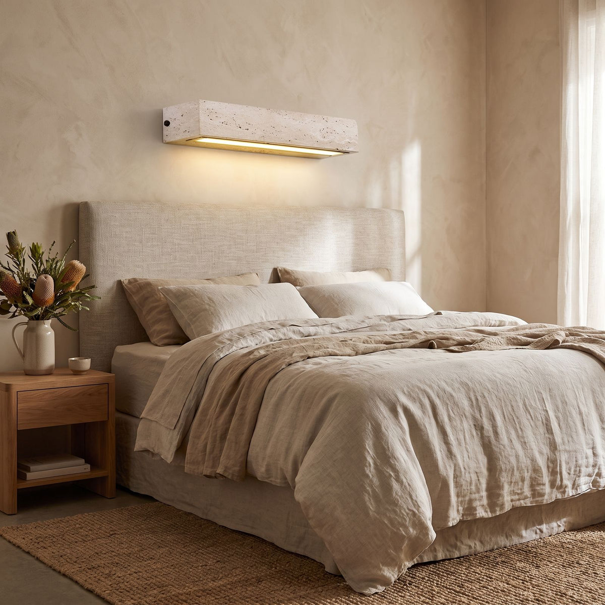 Horizontal Yellow Travertine Bar Wall Light on a bedroom wall beside the bed