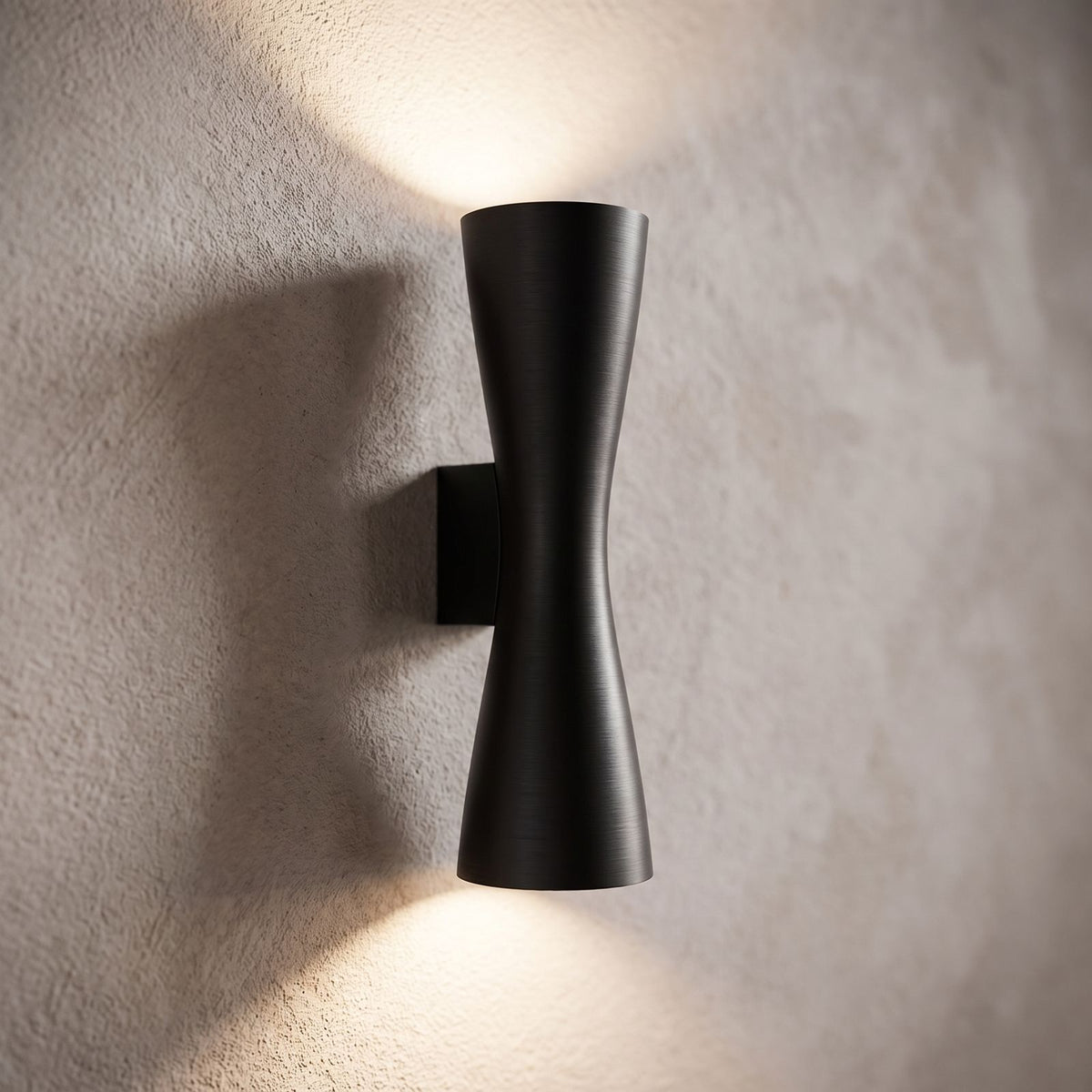 Hourglass Aluminium Up Down Wall Light, close view at 45 degrees on a plaster wall