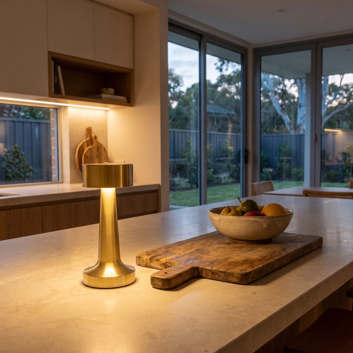 Gold hourglass rechargeable table lamp on a stone kitchen bench