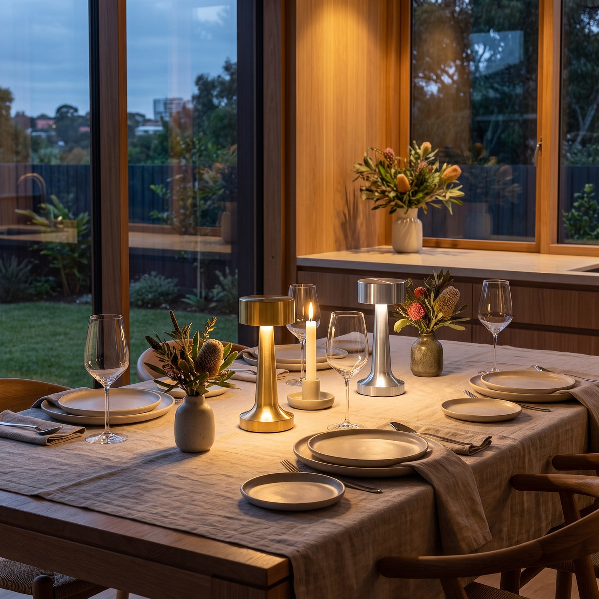 Gold and silver cordless Hourglass table lamps on a set dinner table