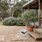 Ice Cube Tempered Glass Solar Path Light on a gravel courtyard in daylight