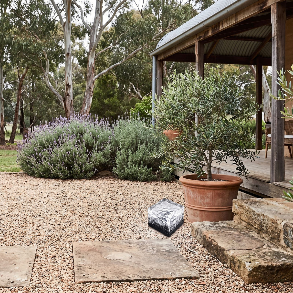 Ice Cube Tempered Glass Solar Path Light on a gravel courtyard in daylight