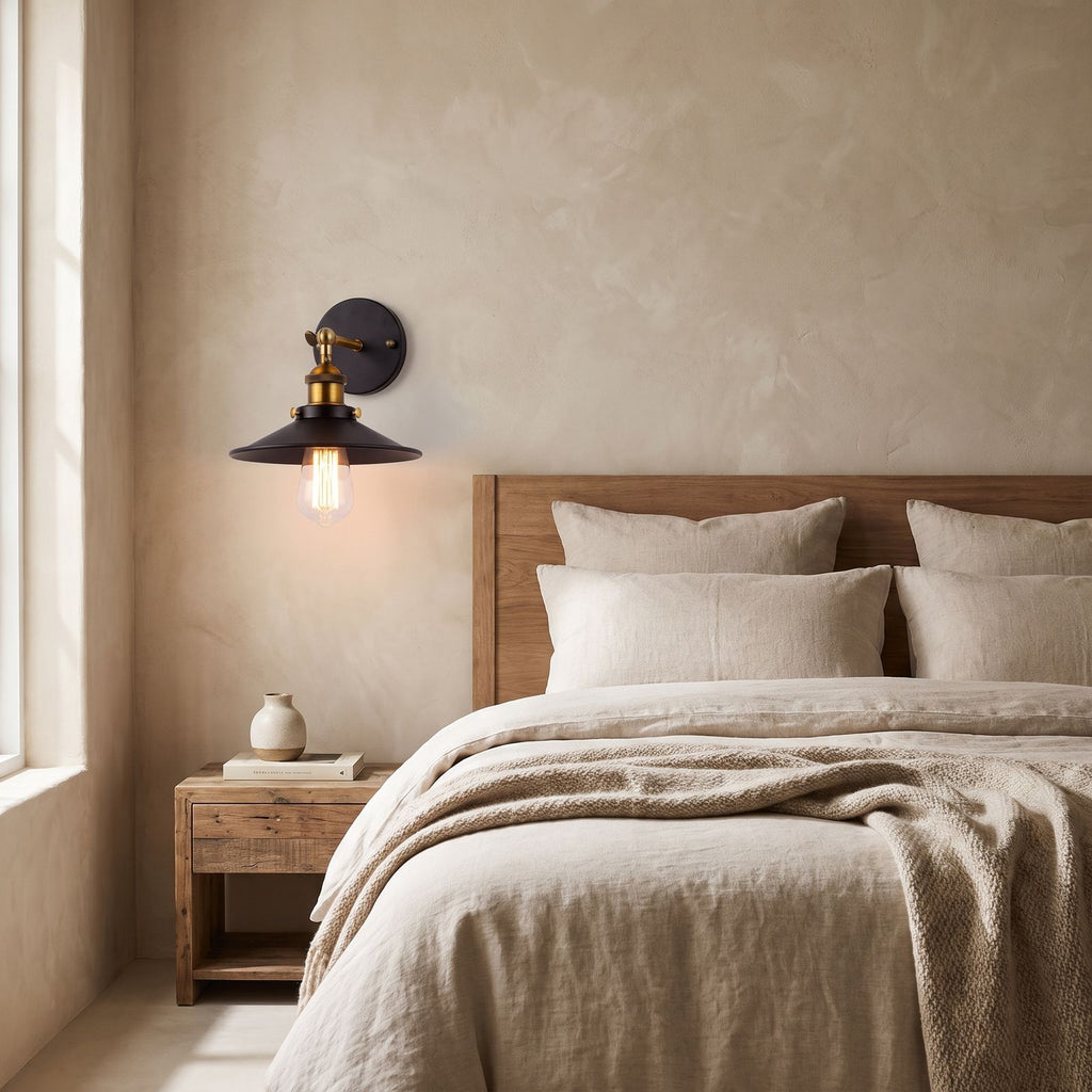 Industrial Saucer Shade Iron Wall Light on a bedroom wall beside the bed