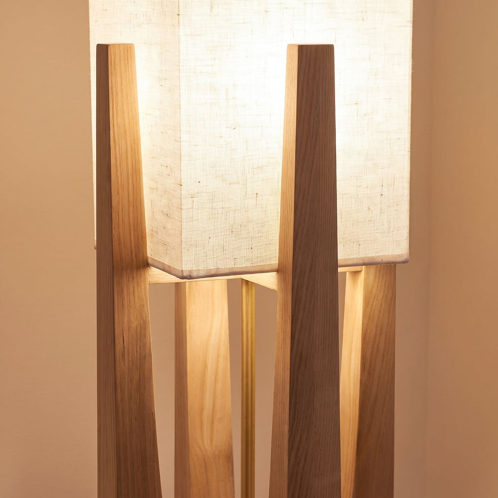 Close-up of the fabric shade set into the tapered wood legs