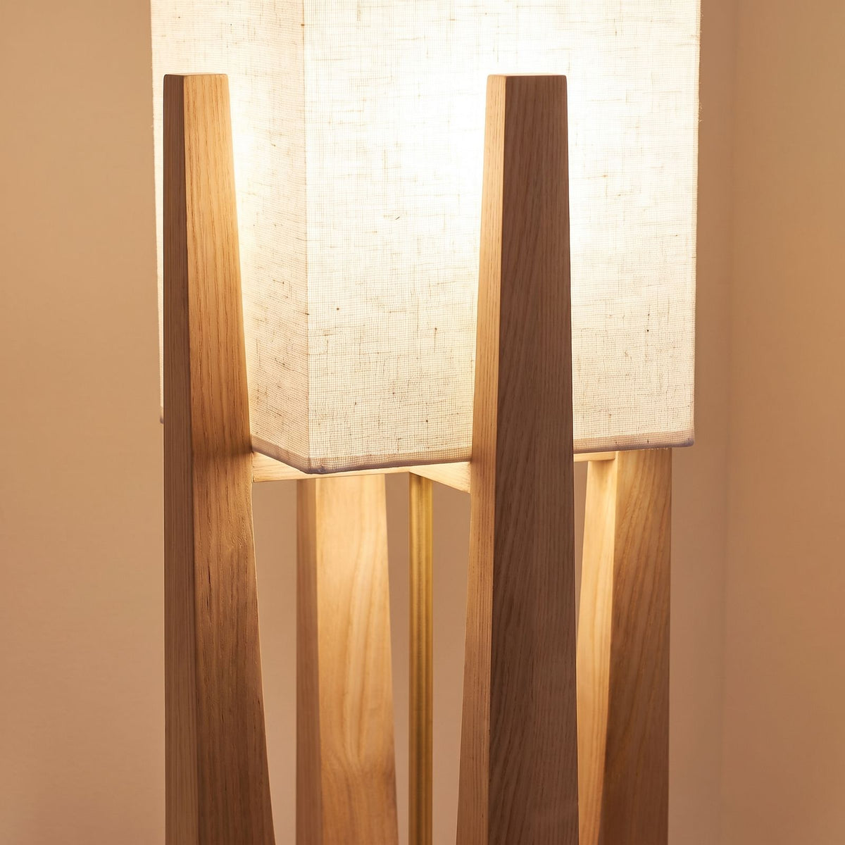 Close-up of the fabric shade set into the tapered wood legs