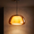 Jelly Glass Dome Pendant Light glowing against a plaster wall at night