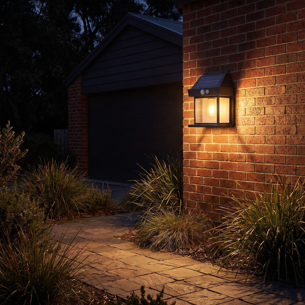 Lantern shape solar sensor wall light on a garage side wall above a path