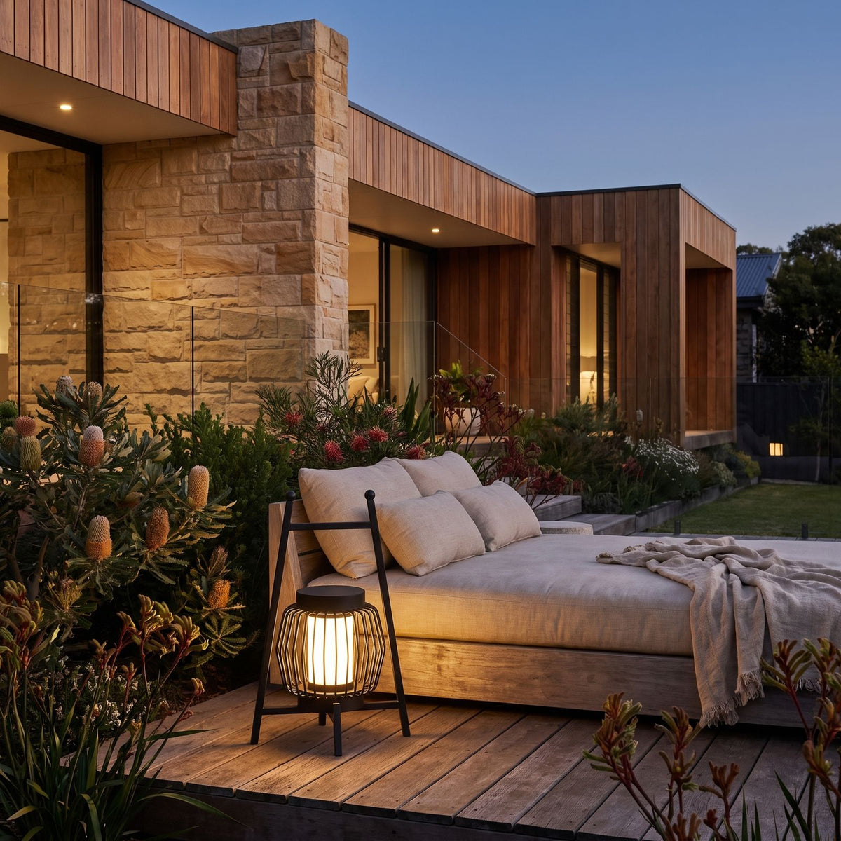 Large Retro Stainless Steel Outdoor Table Lamp on a timber deck beside a daybed