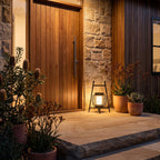 Large Retro Stainless Steel Outdoor Table Lamp beside a front door at night