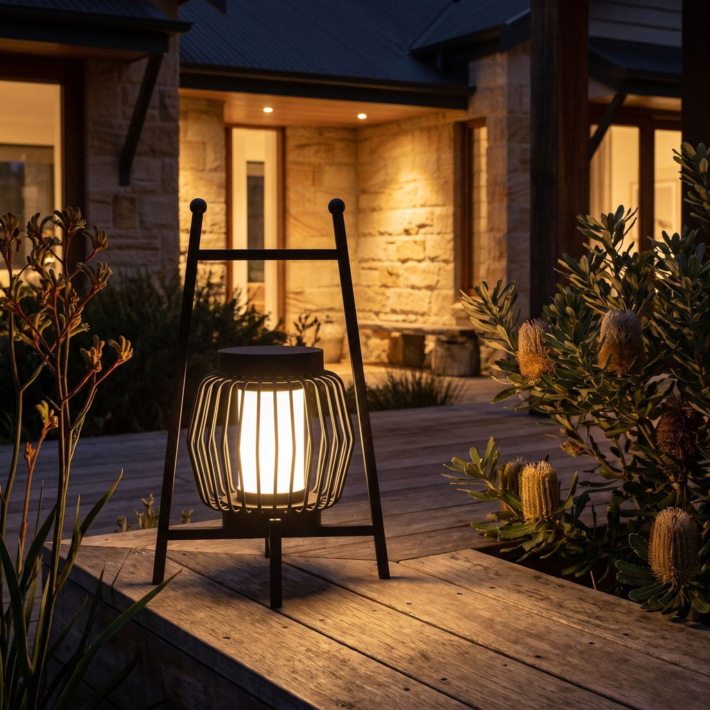Large Retro Stainless Steel Outdoor Table Lamp glowing on a timber deck at night