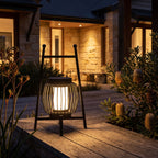 Large Retro Stainless Steel Outdoor Table Lamp glowing on a timber deck at night