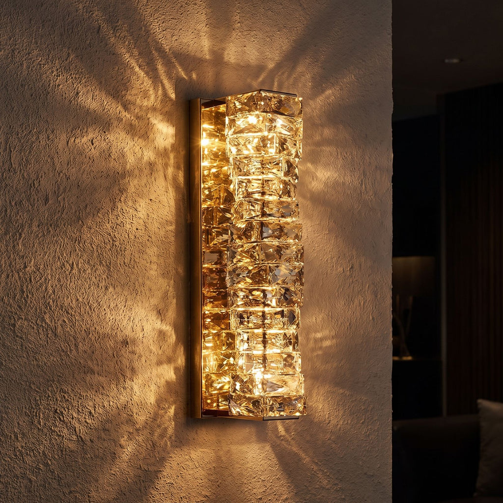 Layered Crystal Ribbon LED Wall Light glowing on a plaster wall at night