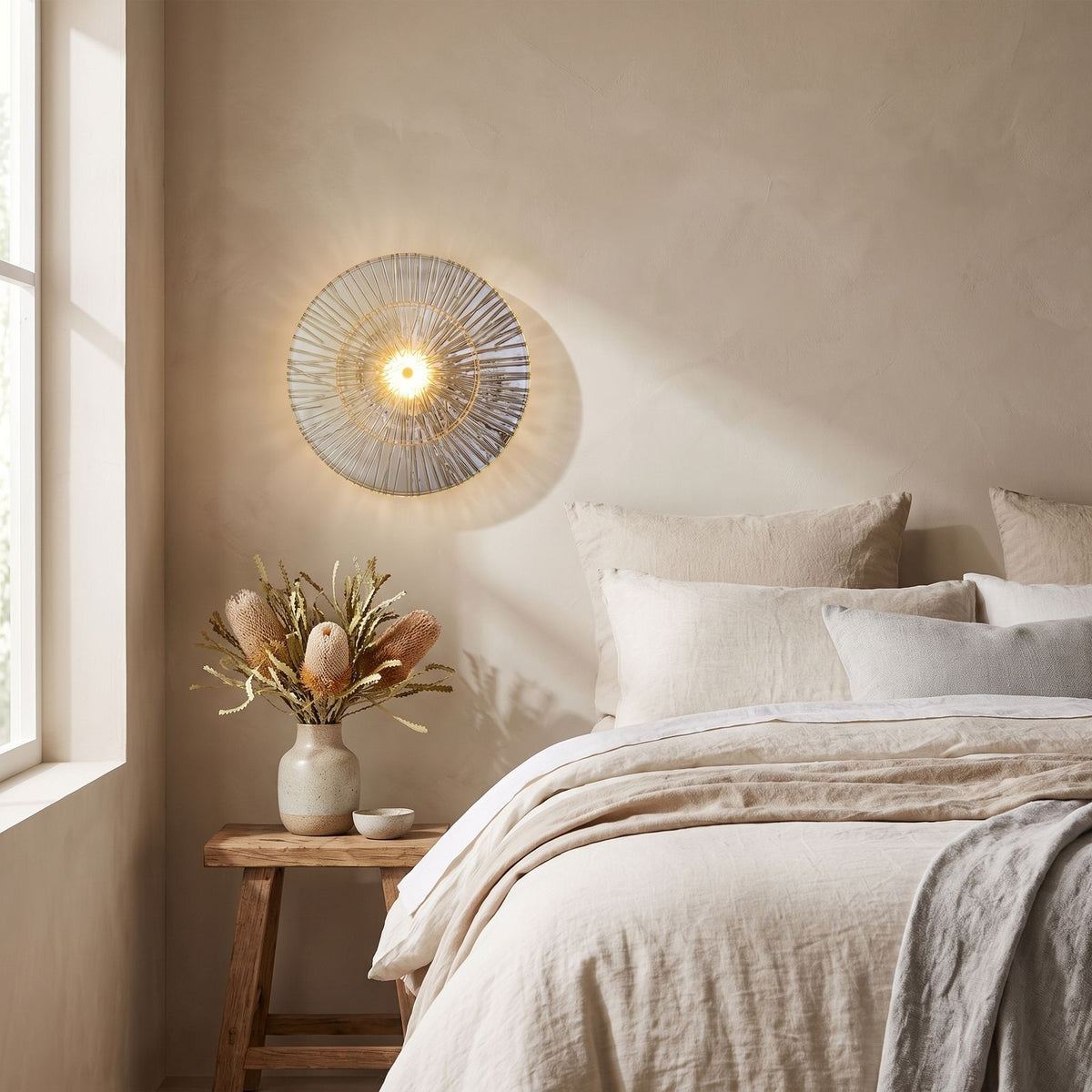 Layered Lotus Glass Round LED Wall Light on a bedroom wall beside the bed
