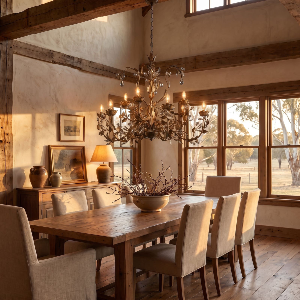 Leaf Branch Iron and Crystal Chandelier in bronze with smoke crystals above a dining table at golden hour
