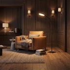 LED Gooseneck Reading Floor Lamp behind a leather armchair in a panelled living room in the evening