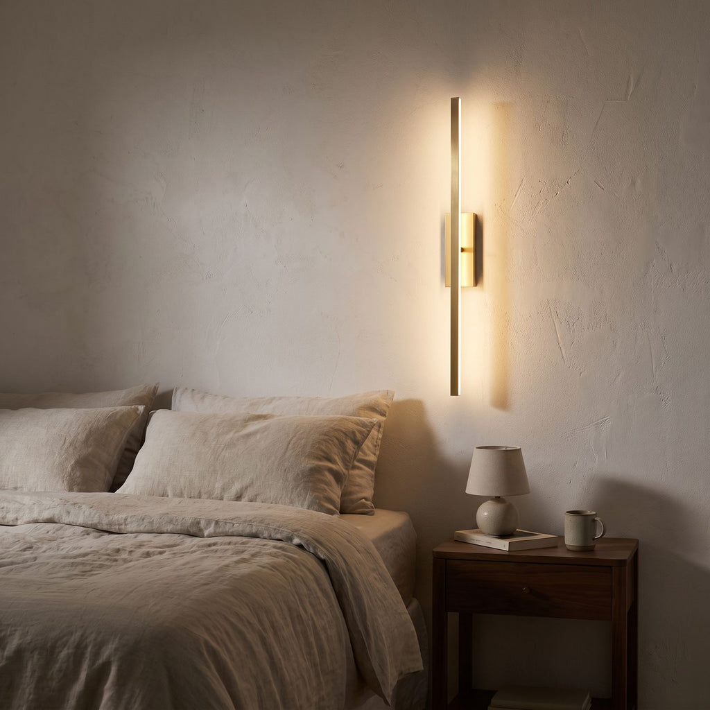 Linear Brushed Brass LED Vanity Wall Light seen in a wider evening interior