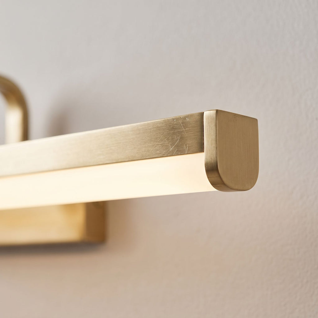 Close view of the material and finish of the Linear Brushed Brass LED Vanity Wall Light