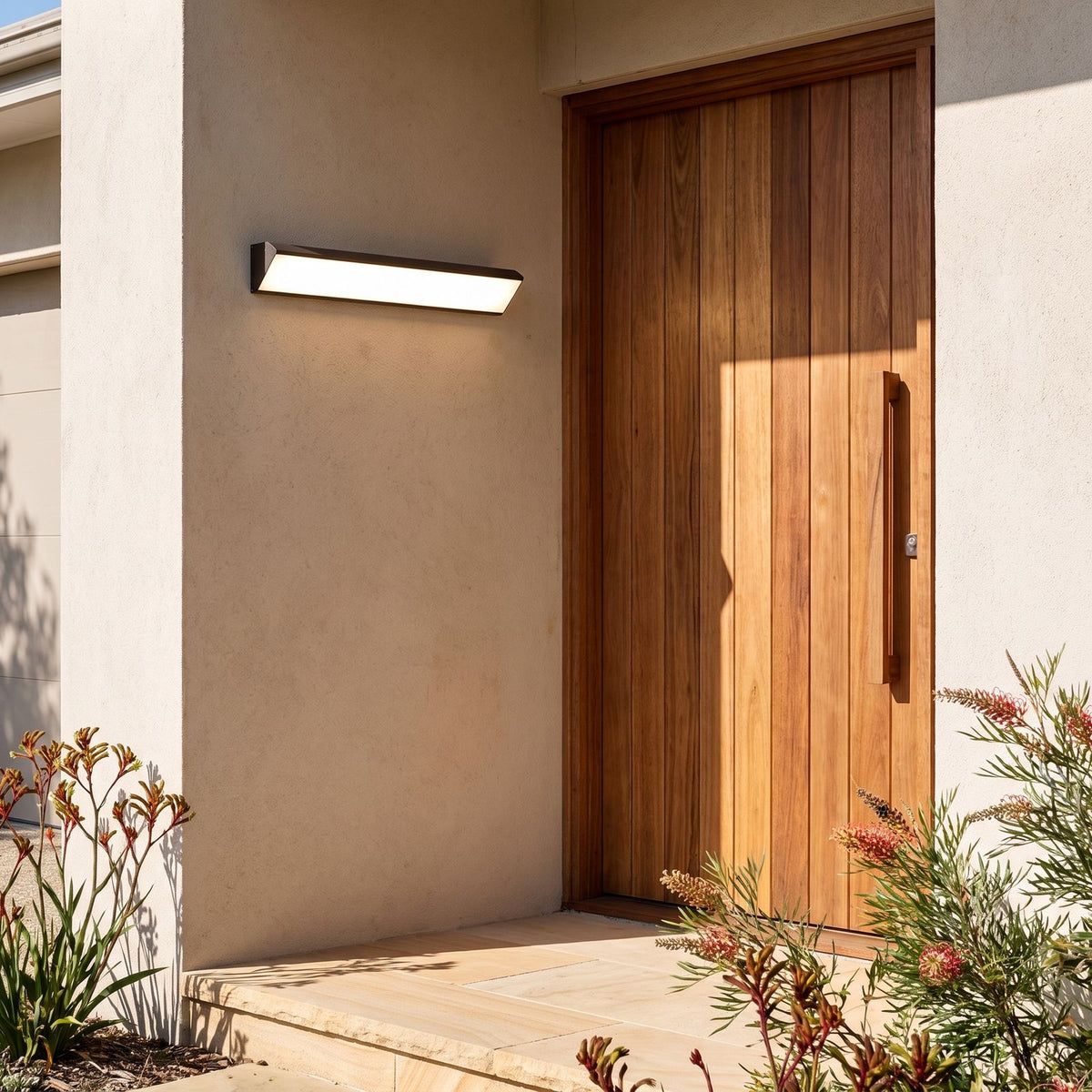 Long Linear Up Down Outdoor Wall Light beside a timber front door
