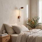 Long Rod Wood Bedside Reading Wall Light on a bedroom wall beside the bed