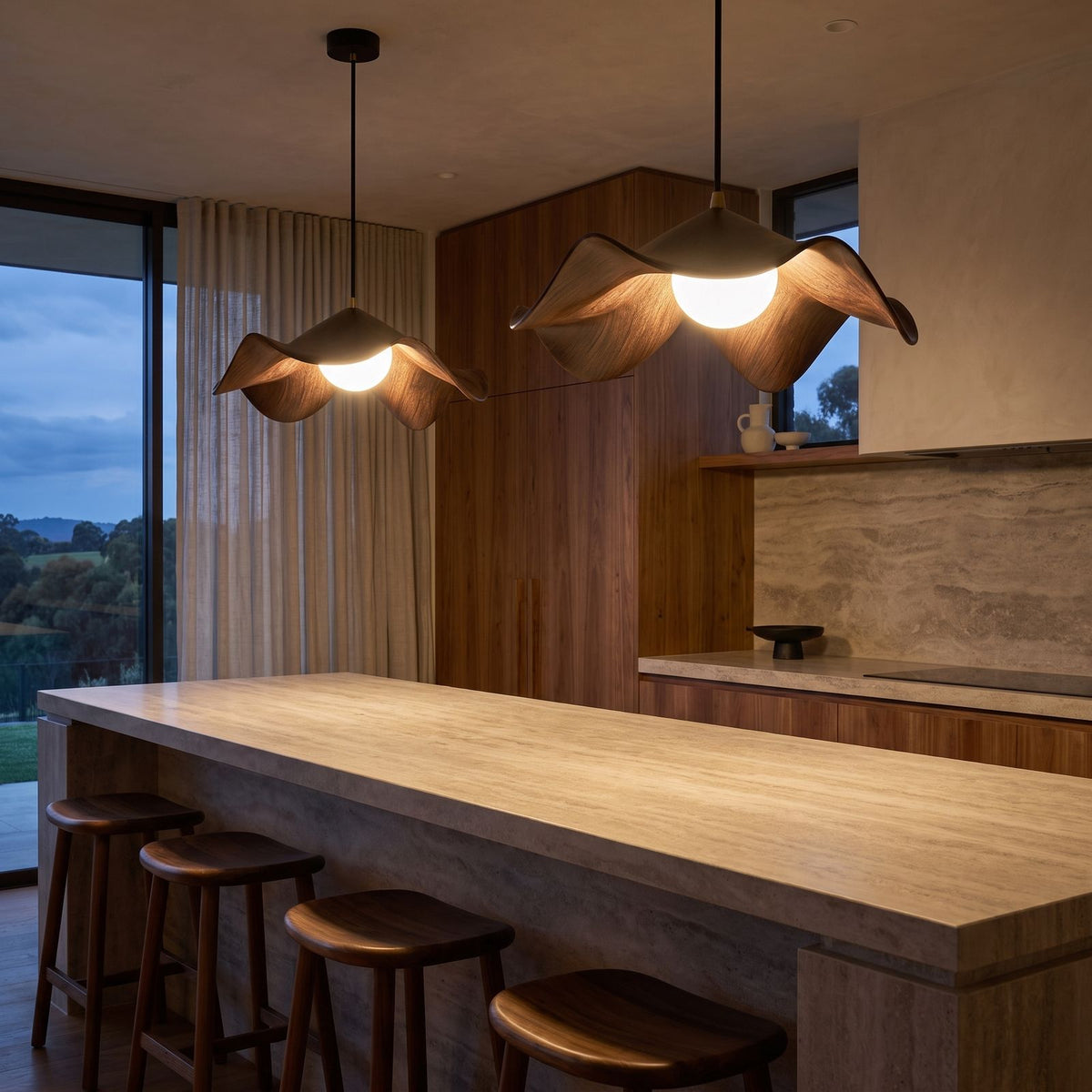 A pair of Lotus Leaf Resin Pendant Lights over a stone kitchen island