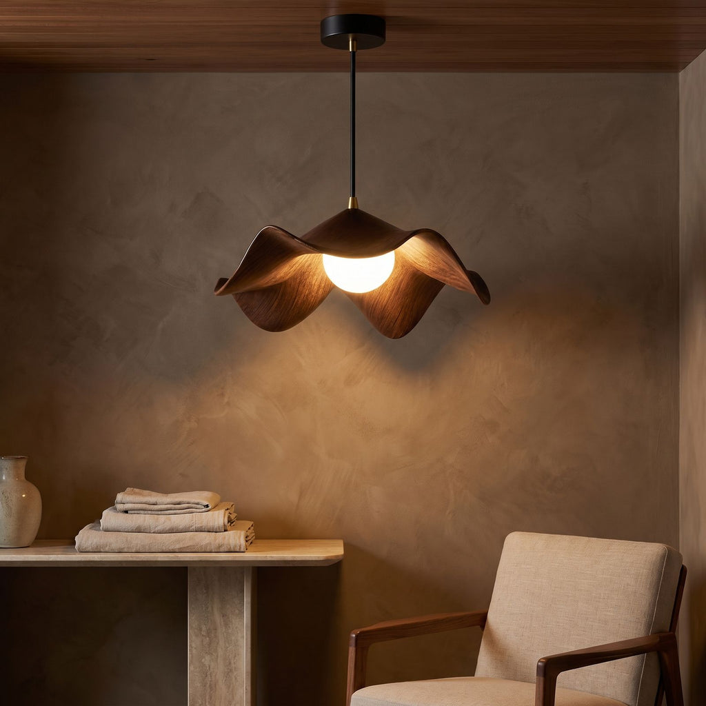Lotus Leaf Resin Pendant Light glowing against a plaster wall at night