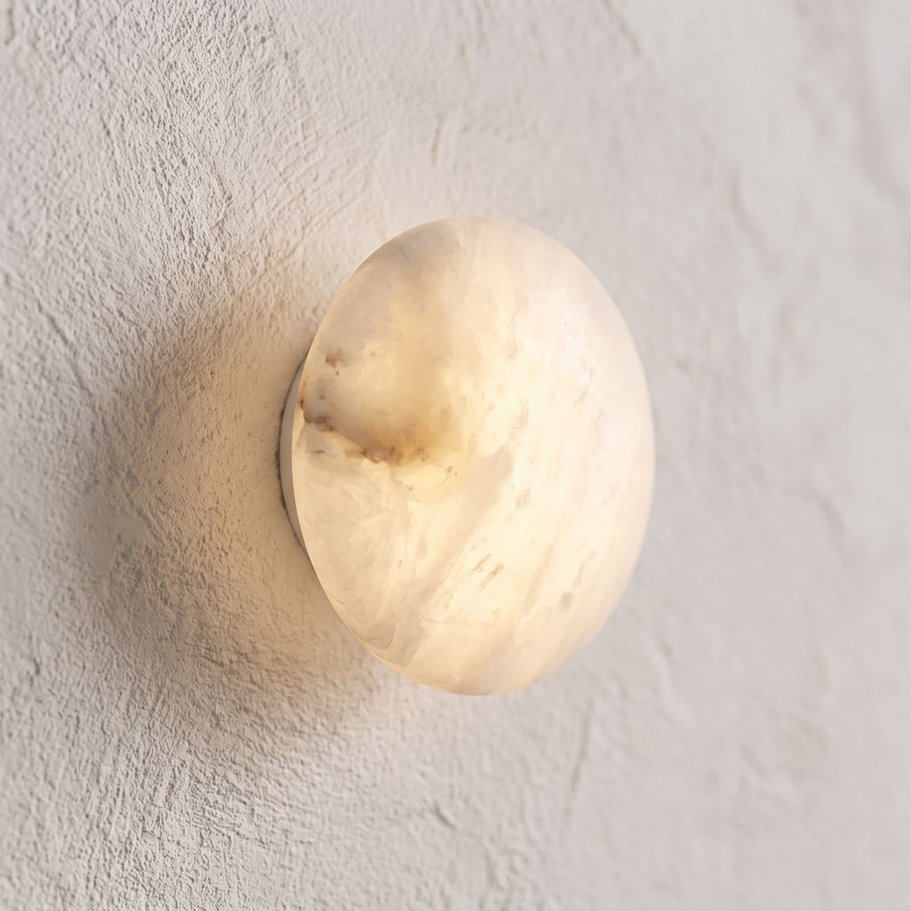 Low-Profile Round Alabaster LED Wall Light, close view at 45 degrees on a plaster wall