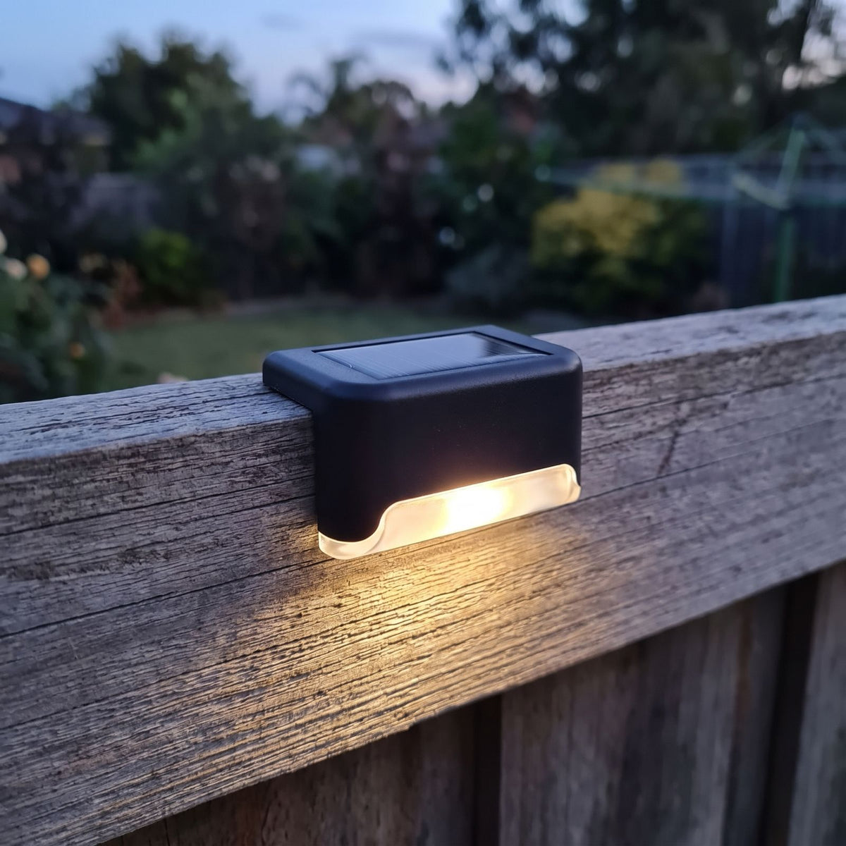 Low Profile Solar Balustrade and Deck Light on a timber fence rail at dusk