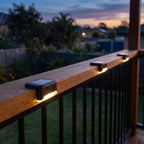 Low profile solar lights on a balcony balustrade rail at dusk