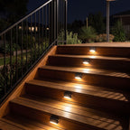 Low profile solar lights on the risers of a timber deck staircase
