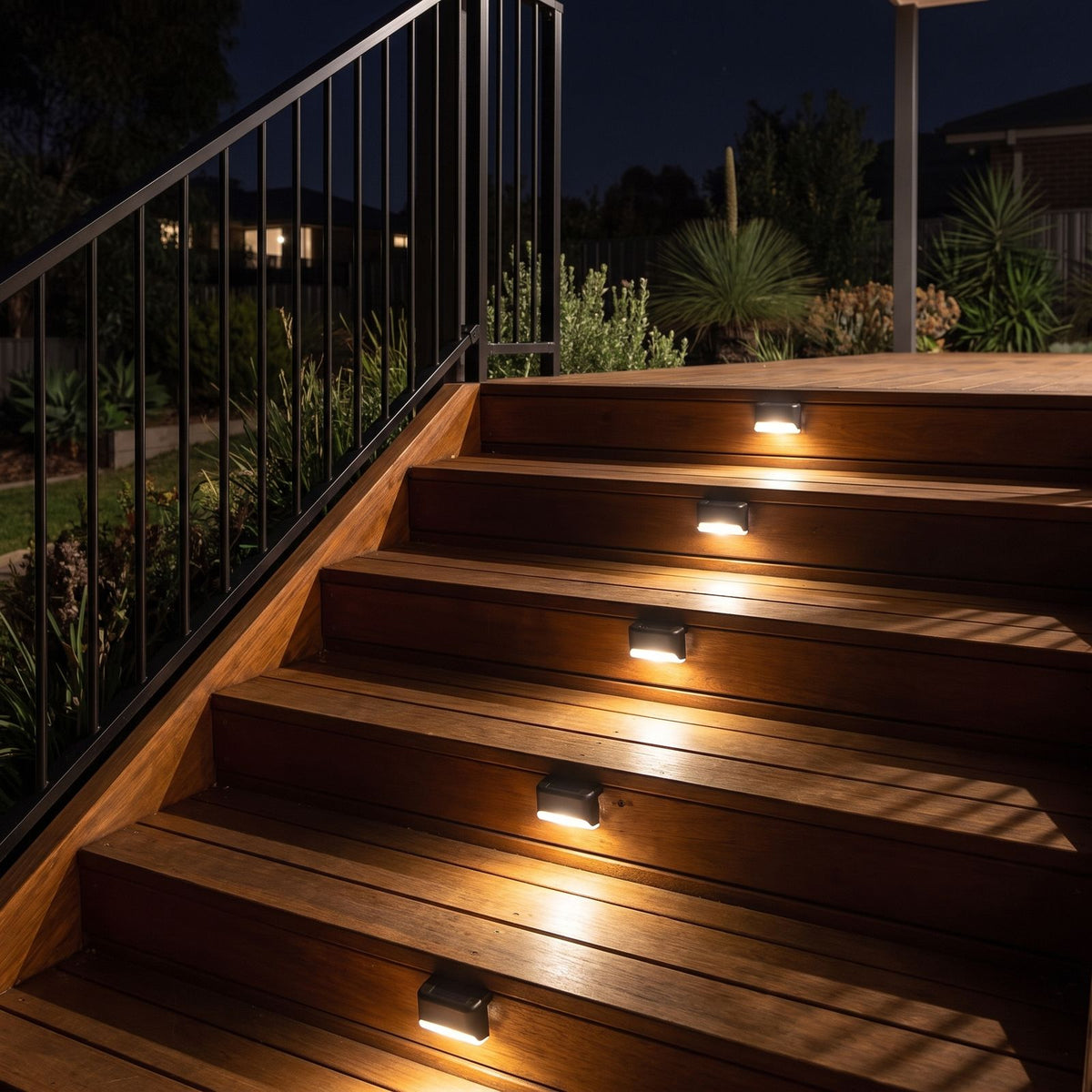 Low profile solar lights on the risers of a timber deck staircase