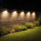 Low profile solar lights along a timber slat fence at night