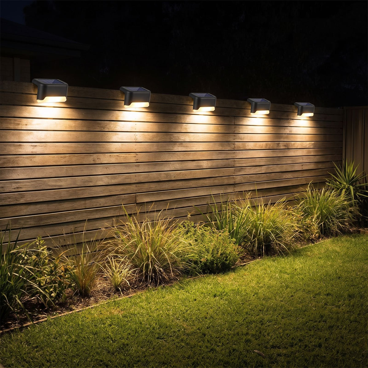 Low profile solar lights along a timber slat fence at night
