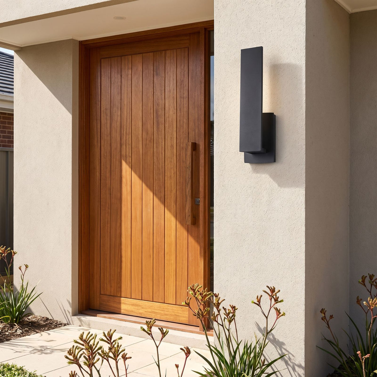 Matte Black Aluminium Lantern Outdoor Wall Light beside a timber front door