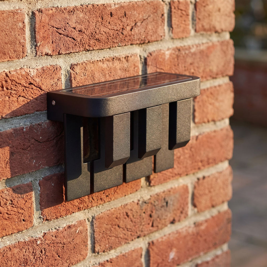 Matte Black Metal Outdoor Wall Light, close view at 45 degrees on a stone wall