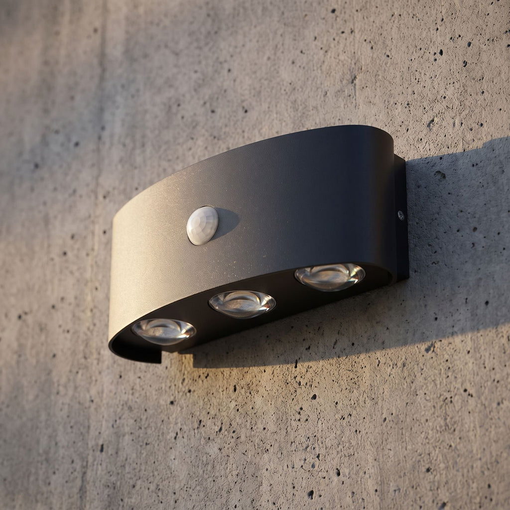 Metal and Acrylic Up Down Outdoor Wall Light, close view at 45 degrees on a stone wall