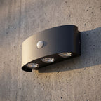 Metal and Acrylic Up Down Outdoor Wall Light, close view at 45 degrees on a stone wall