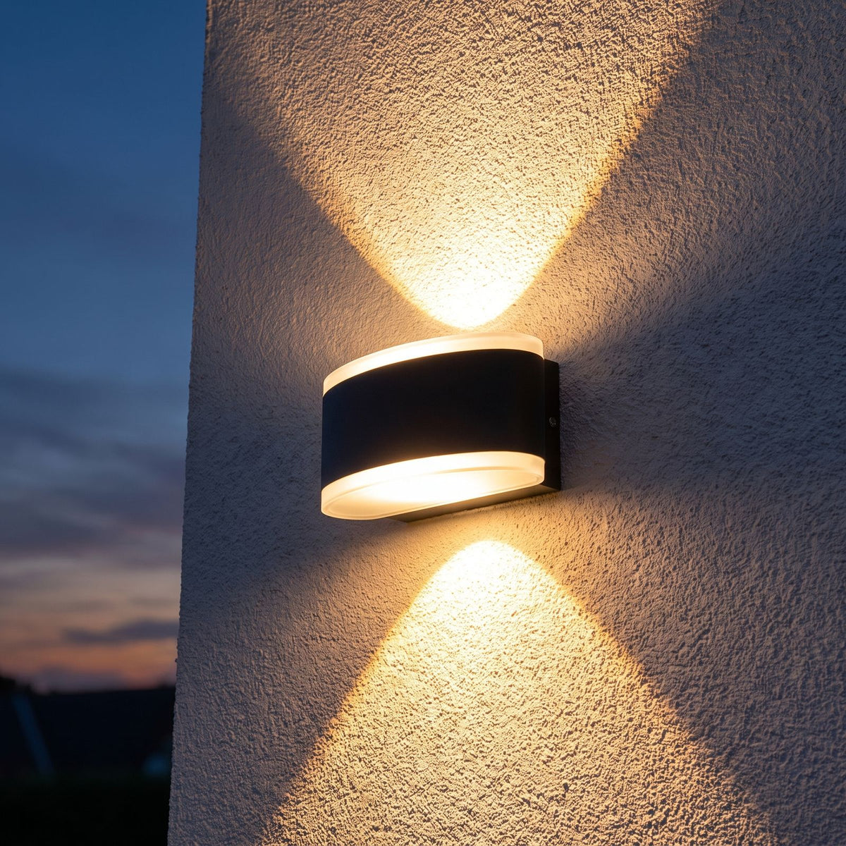 Metal and Acrylic Up Down Outdoor Wall Light on a porch wall at dusk