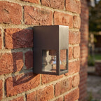 Metal and Glass GU10 Outdoor Wall Light, close view at 45 degrees on a stone wall